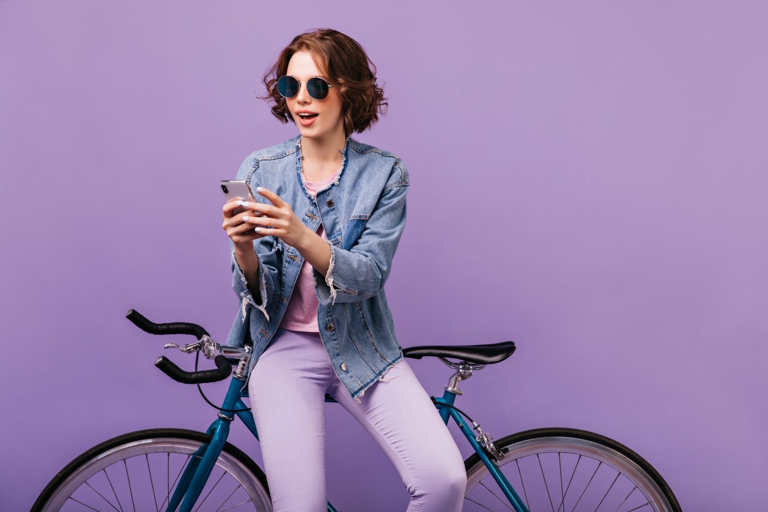 Person with bike on purple background