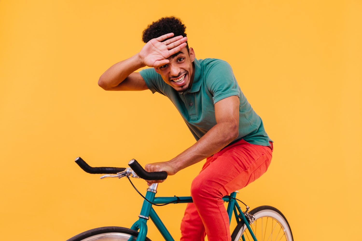 Person on bike on yellow background