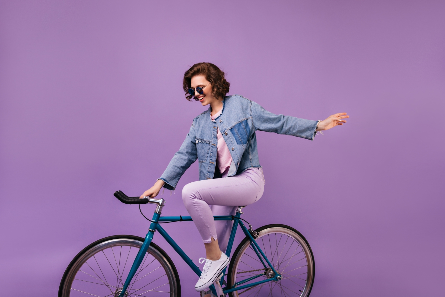 Person on bike on purple background