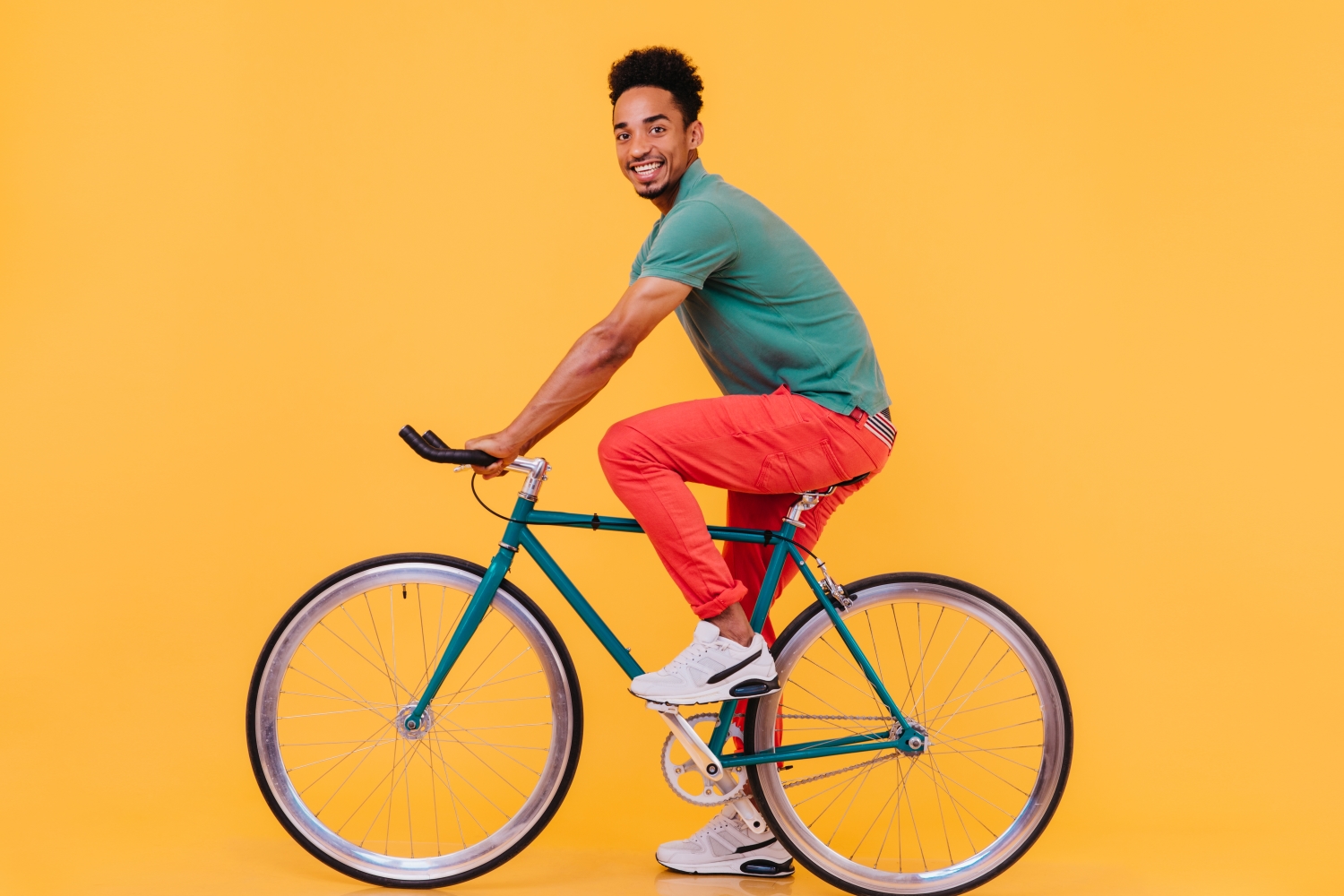 Person on bike on yellow background